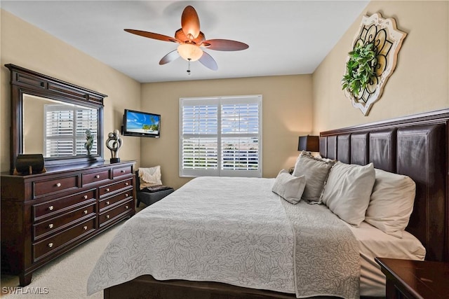 bedroom featuring light carpet and ceiling fan