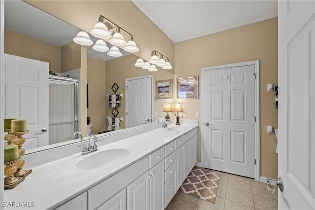 bathroom with tile patterned flooring, toilet, a sink, double vanity, and a stall shower