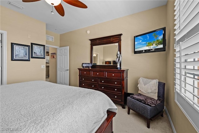 bedroom with light carpet, baseboards, visible vents, and a ceiling fan