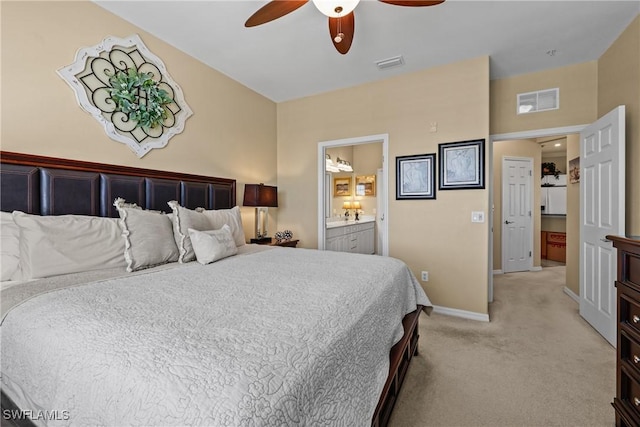 bedroom featuring light carpet, baseboards, visible vents, a ceiling fan, and ensuite bath