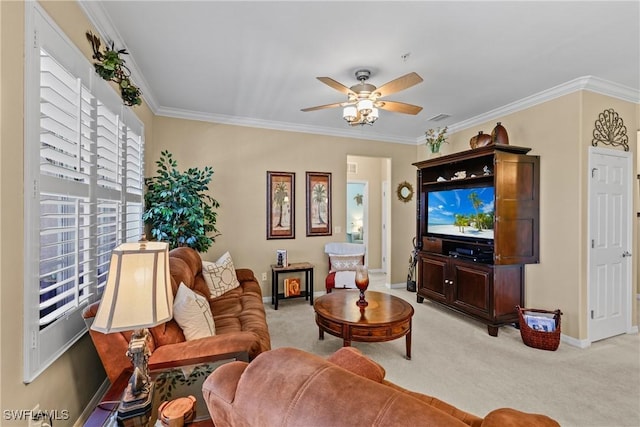 living area featuring ceiling fan, light colored carpet, visible vents, baseboards, and crown molding