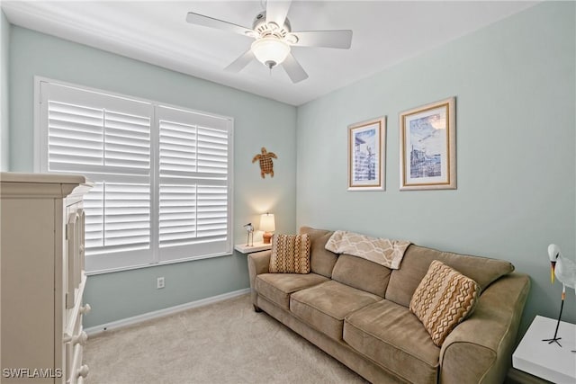 living room featuring carpet, baseboards, and a ceiling fan