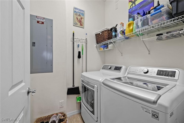 clothes washing area with laundry area, electric panel, baseboards, and independent washer and dryer