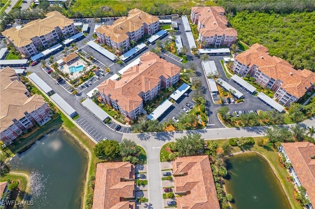 drone / aerial view featuring a water view and a residential view