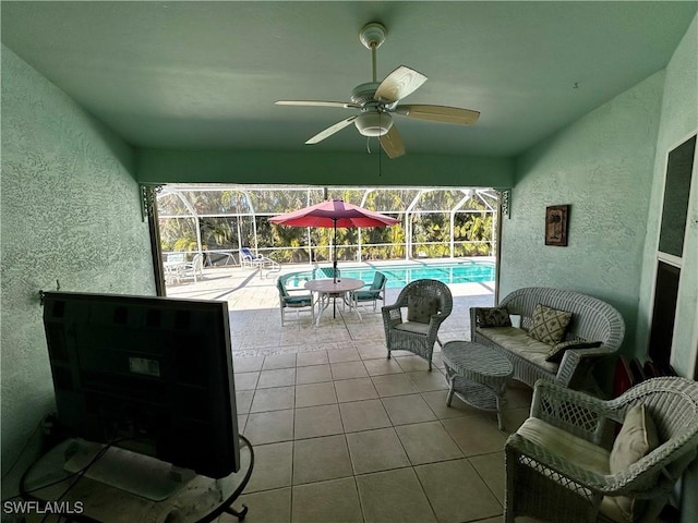 sunroom / solarium with ceiling fan and a swimming pool