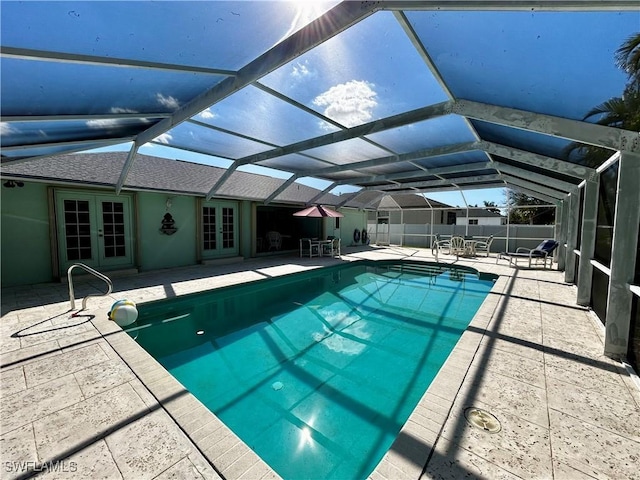 view of pool featuring a lanai, fence, french doors, a fenced in pool, and a patio area