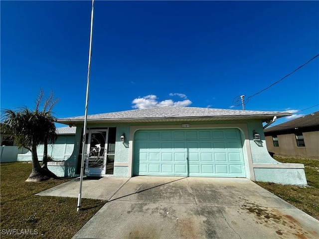 single story home with concrete driveway, an attached garage, and stucco siding