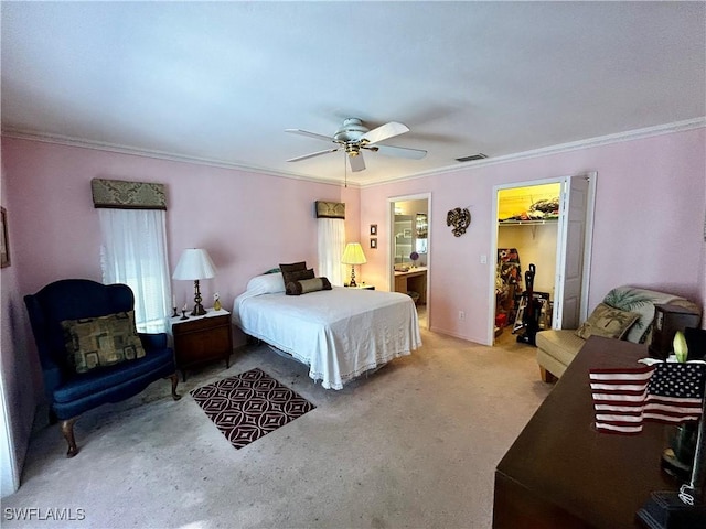 carpeted bedroom with visible vents, connected bathroom, ceiling fan, ornamental molding, and a spacious closet