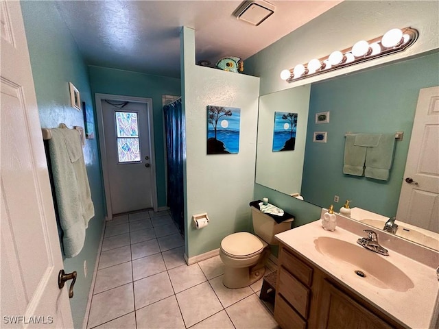 full bathroom with toilet, a shower with shower curtain, visible vents, vanity, and tile patterned floors