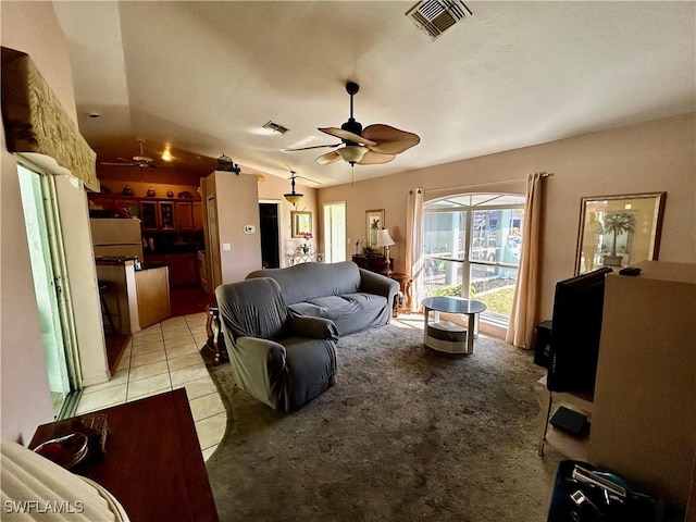 living room with lofted ceiling, light tile patterned floors, ceiling fan, and visible vents