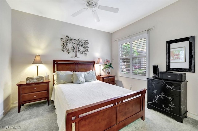 bedroom featuring light carpet, baseboards, and a ceiling fan