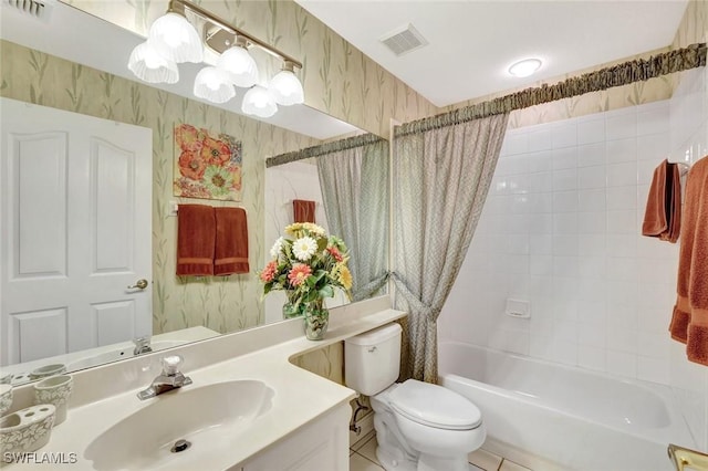 bathroom featuring toilet, wallpapered walls, and visible vents