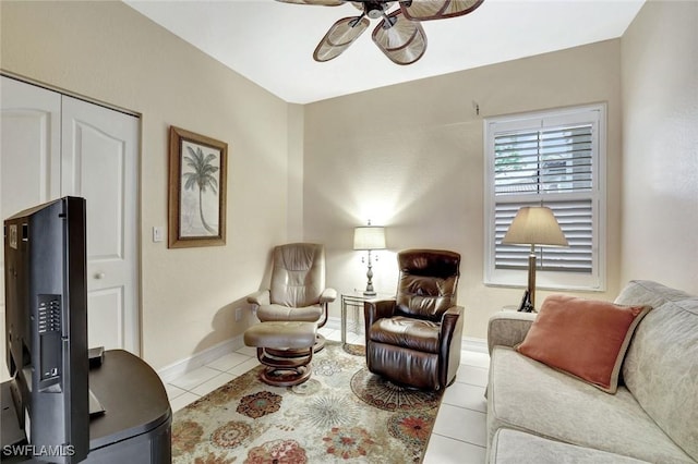 living room with ceiling fan, baseboards, and tile patterned floors