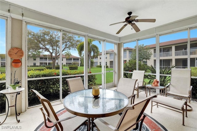 sunroom / solarium featuring a ceiling fan