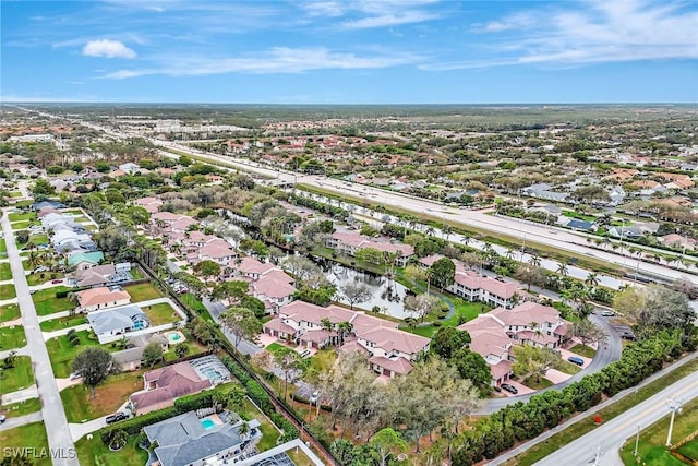 drone / aerial view with a water view and a residential view