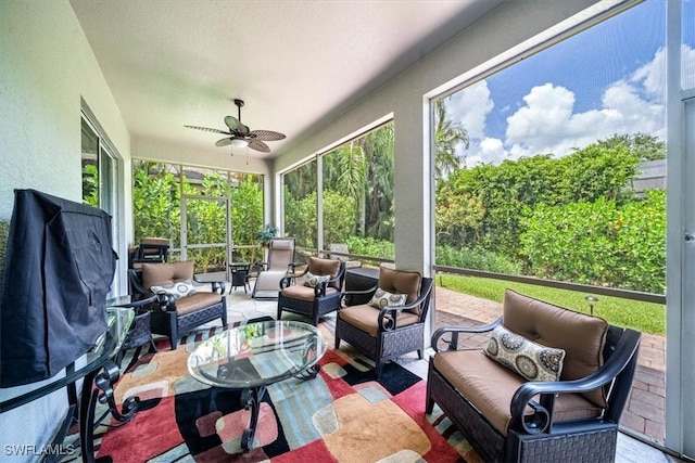 sunroom featuring ceiling fan