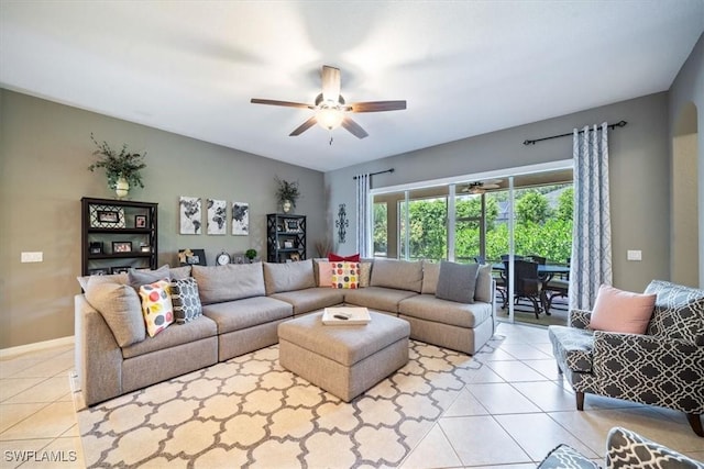 living area featuring light tile patterned floors, vaulted ceiling, and a ceiling fan