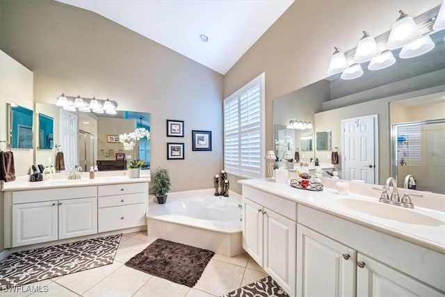 full bathroom featuring a garden tub, a sink, vaulted ceiling, a shower stall, and tile patterned floors