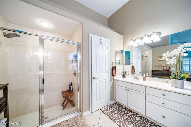 bathroom with a stall shower, tile patterned flooring, and vanity