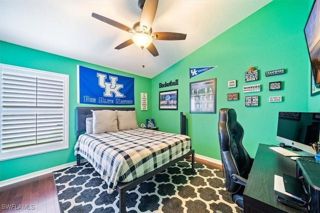 bedroom with lofted ceiling, a ceiling fan, baseboards, and wood finished floors