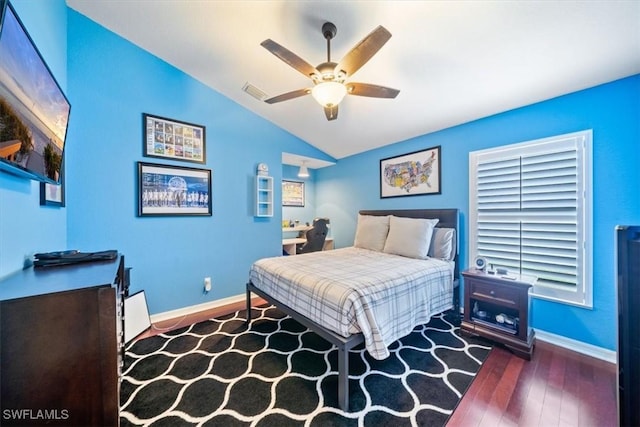 bedroom featuring visible vents, baseboards, vaulted ceiling, and wood finished floors