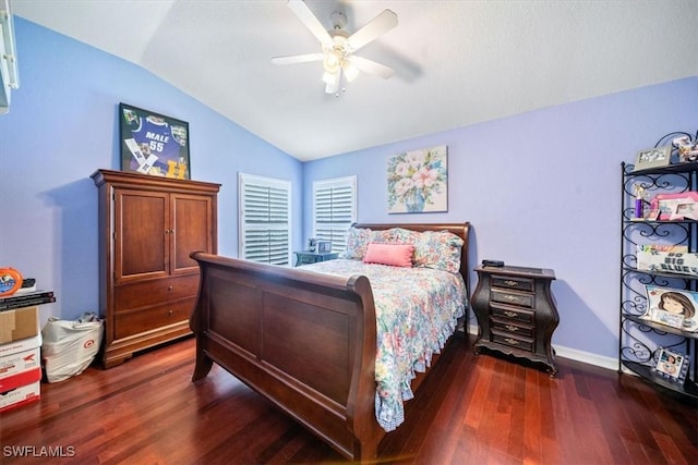 bedroom with lofted ceiling, ceiling fan, baseboards, and dark wood finished floors