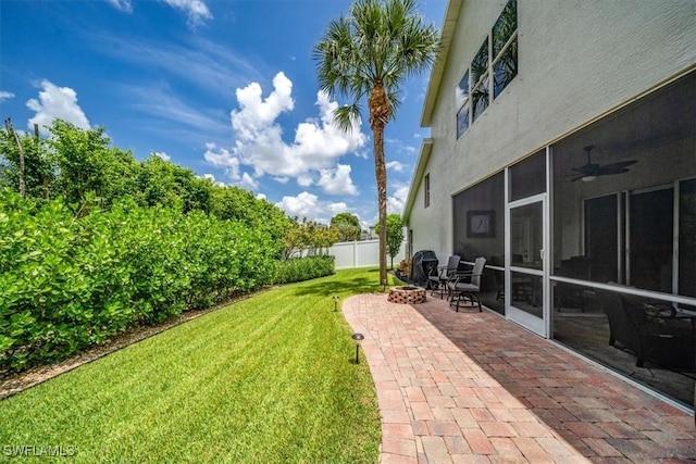 view of yard with a sunroom, a patio area, and fence