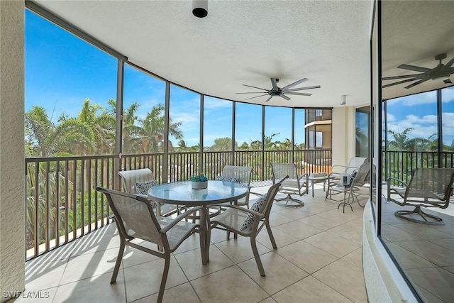 sunroom featuring ceiling fan