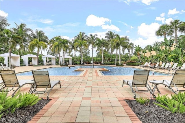 pool with a patio area and a gazebo