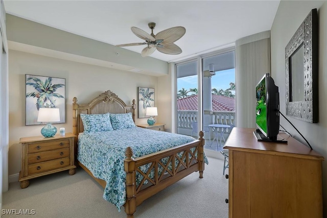 bedroom featuring access to outside, a wall of windows, and light colored carpet