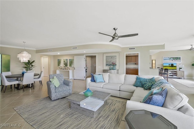 living area with light tile patterned floors, crown molding, visible vents, and ceiling fan with notable chandelier