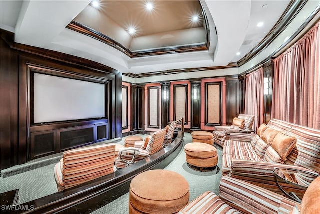 home theater featuring ornamental molding, a raised ceiling, and recessed lighting