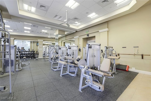 gym with a ceiling fan, visible vents, and a drop ceiling