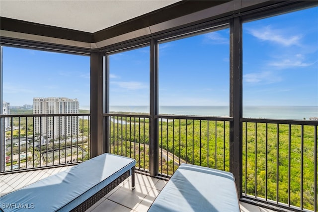 sunroom / solarium with a water view