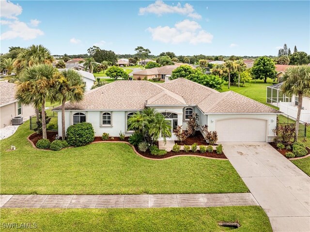 mediterranean / spanish-style home featuring central AC unit, an attached garage, concrete driveway, stucco siding, and a front lawn