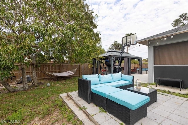 view of patio featuring a gazebo, fence, and an outdoor living space