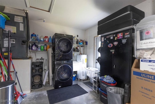 laundry room with attic access, stacked washer / dryer, laundry area, and electric water heater