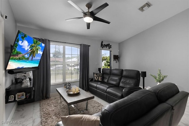 living room with baseboards, marble finish floor, visible vents, and a ceiling fan