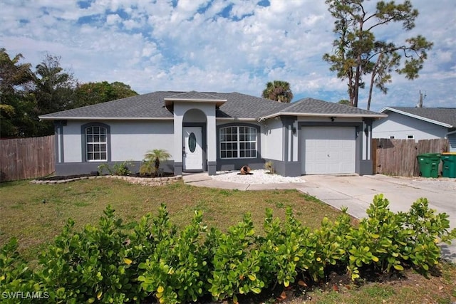 ranch-style house featuring concrete driveway, fence, an attached garage, and stucco siding