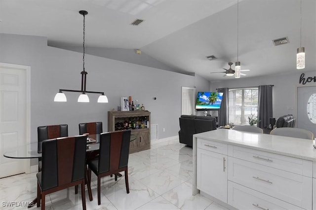 kitchen featuring visible vents, marble finish floor, vaulted ceiling, white cabinetry, and pendant lighting