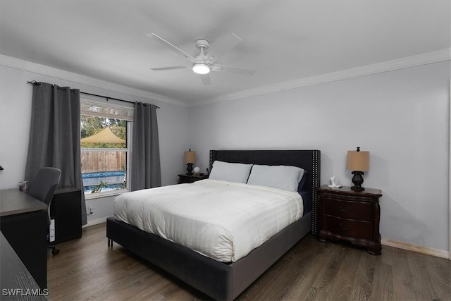 bedroom featuring dark wood-style floors, ornamental molding, baseboards, and a ceiling fan