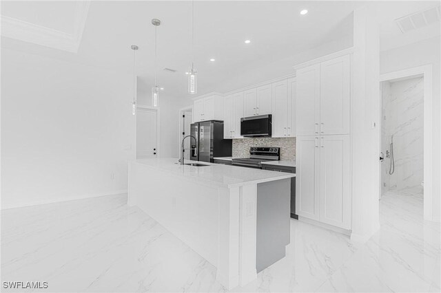 kitchen with a sink, visible vents, marble finish floor, appliances with stainless steel finishes, and an island with sink