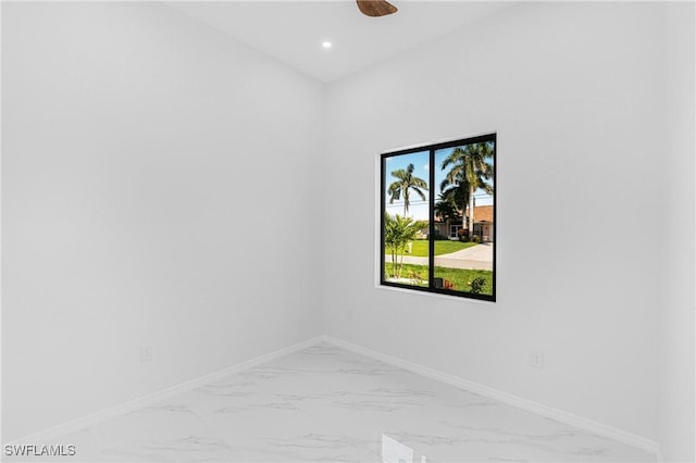 spare room featuring ceiling fan, marble finish floor, recessed lighting, and baseboards