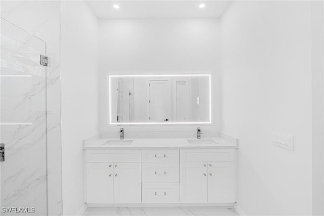 bathroom with marble finish floor, a sink, and a marble finish shower