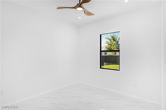 spare room featuring recessed lighting, marble finish floor, ceiling fan, and baseboards