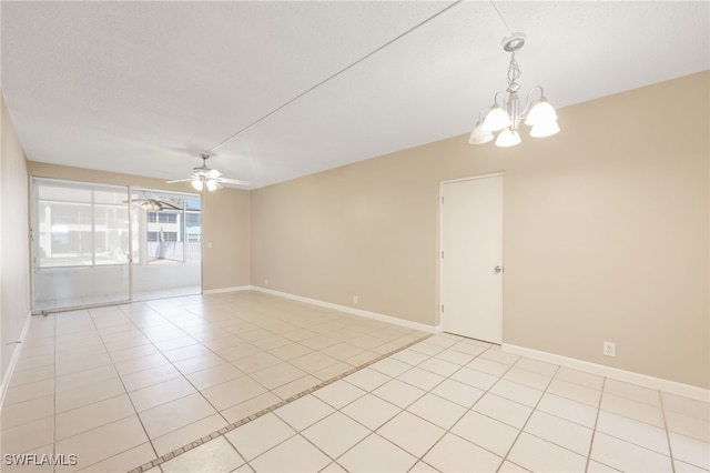 unfurnished room featuring light tile patterned flooring, a textured ceiling, baseboards, and ceiling fan with notable chandelier