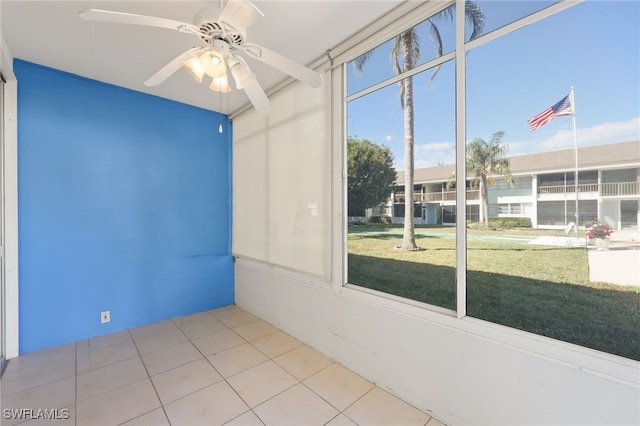 spare room with a ceiling fan and tile patterned floors