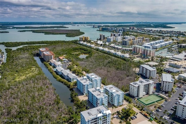 birds eye view of property with a water view and a city view