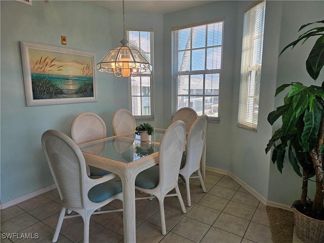 dining room featuring baseboards and light tile patterned floors