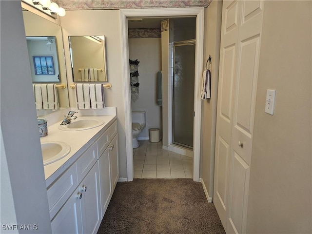 full bathroom featuring toilet, a stall shower, and a sink